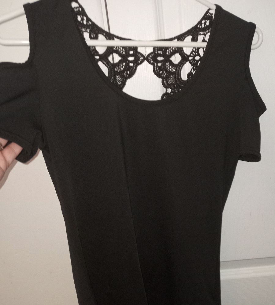 Women's black SM.short-sleeved Shirt with an open design in the back.
